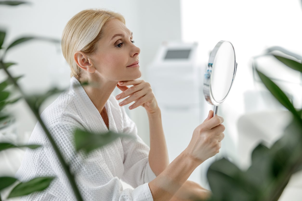 Side view of attractive female enjoying time in beauty salon stock photo