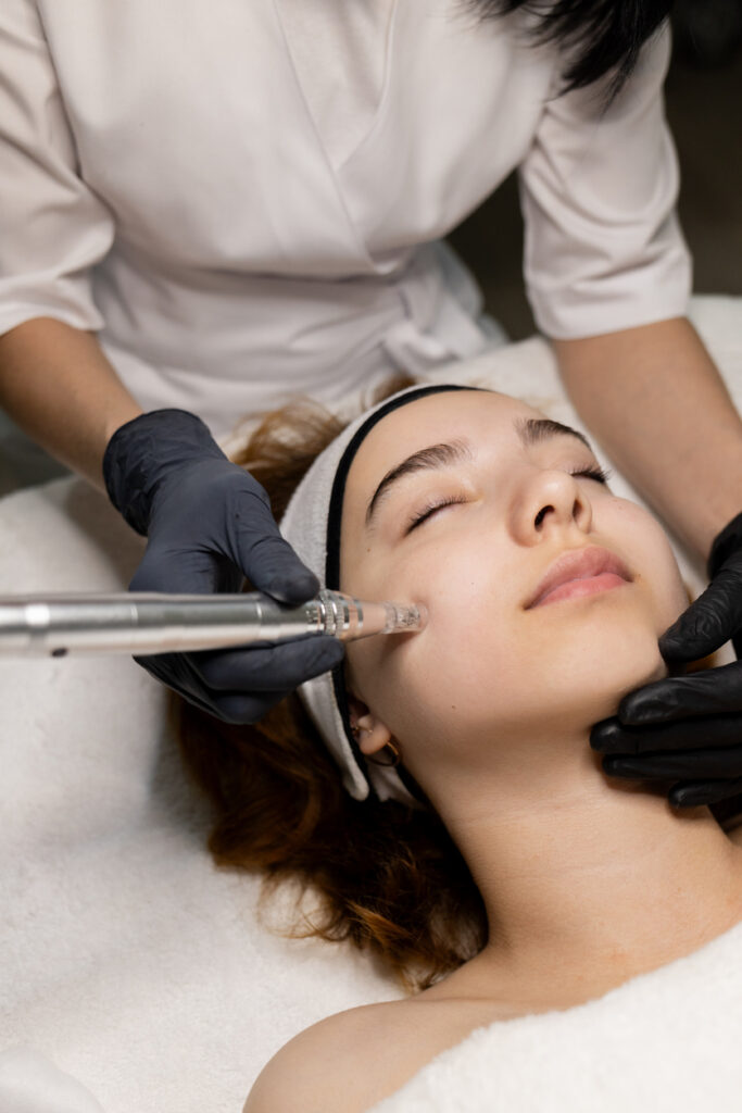 Fractional mesotherapy. A young beautiful woman in the cosmetologist’s office receives fractional mesotherapy for her face. Facial skin rejuvenation. Acne treatment. Hardware cosmetology. Beautician. High quality photo