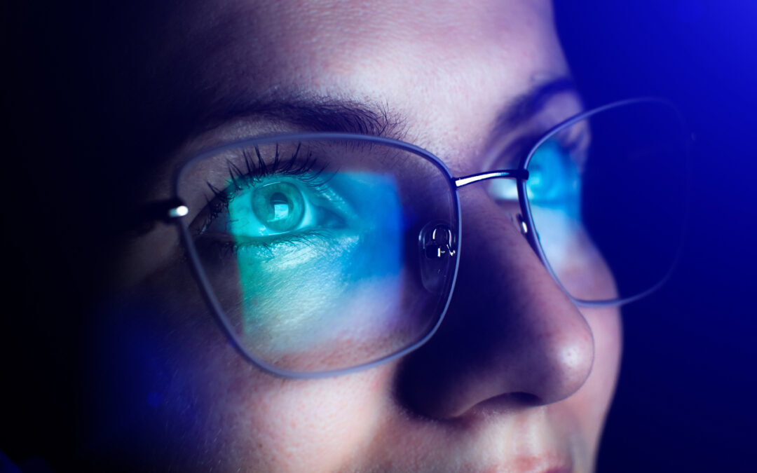 Girl works on internet. Reflection at the glasses from laptop. Close up of woman's eyes with black female glasses for working at a computer. Eye protection from blue light and rays.